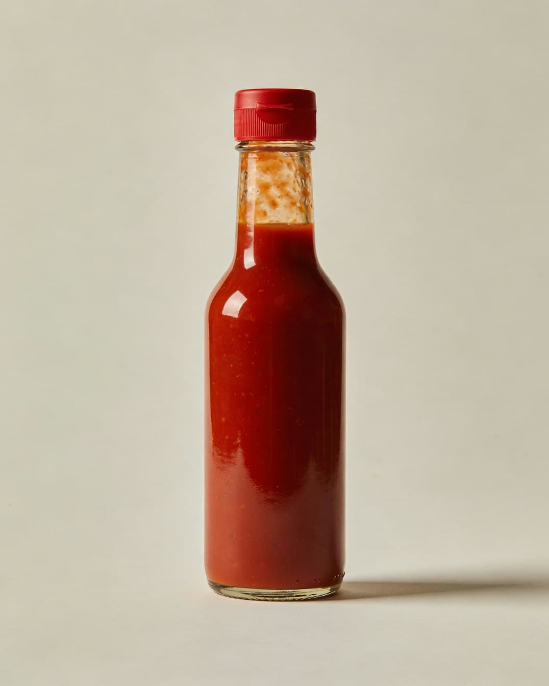 A bottle of bright red homemade peri-peri chili sauce