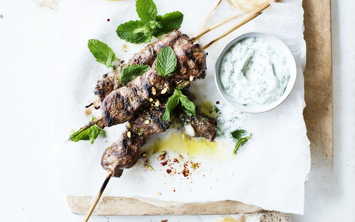Spiced grilled meat skewers with fresh mint and a cool yogurt dip