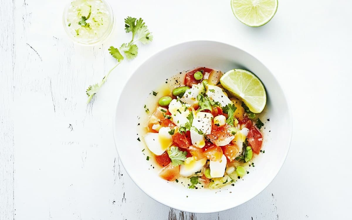 A bowl of fresh ceviche with tomato, lime and cilantro